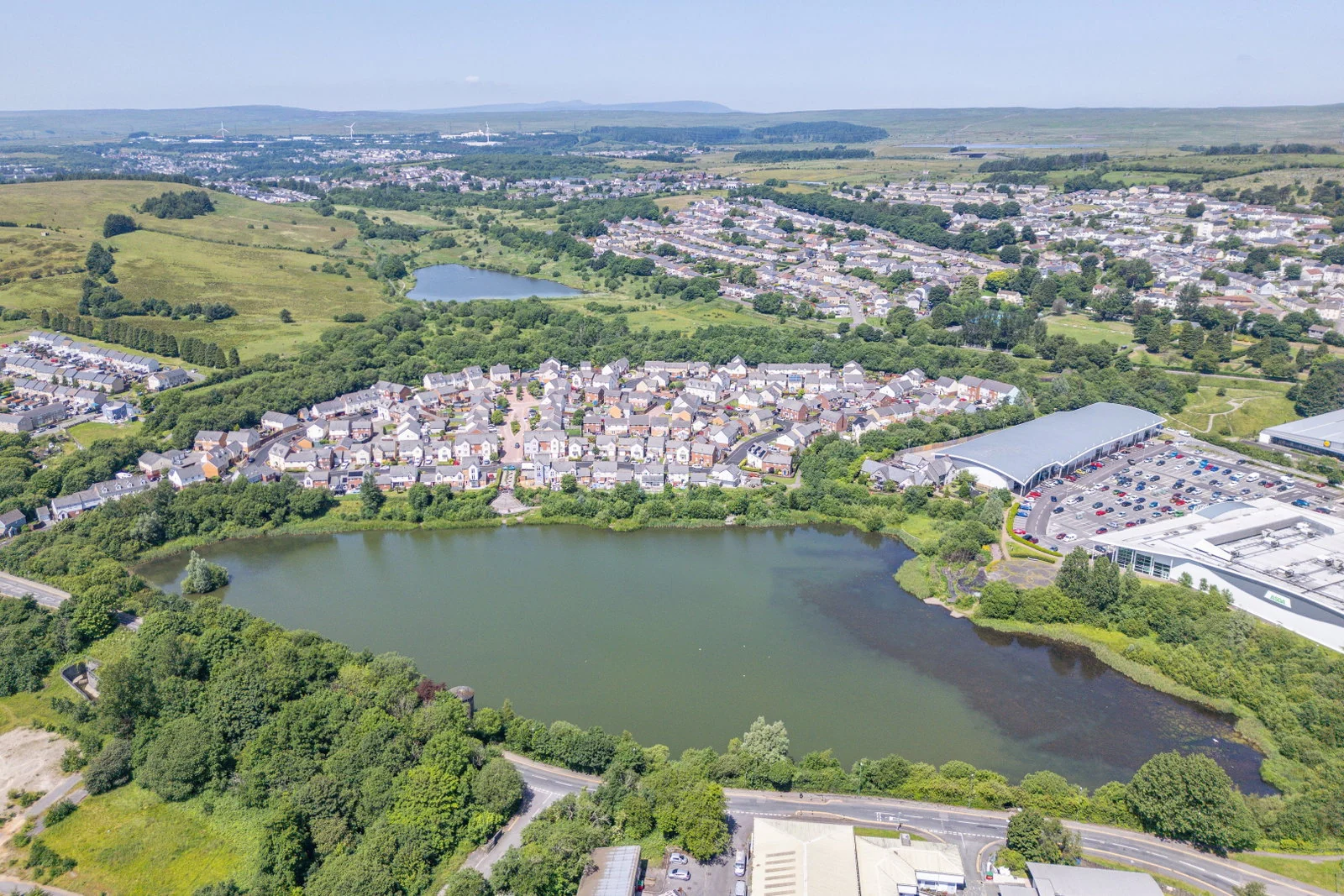 Aerial view of the lake set into the valley with the town beyond