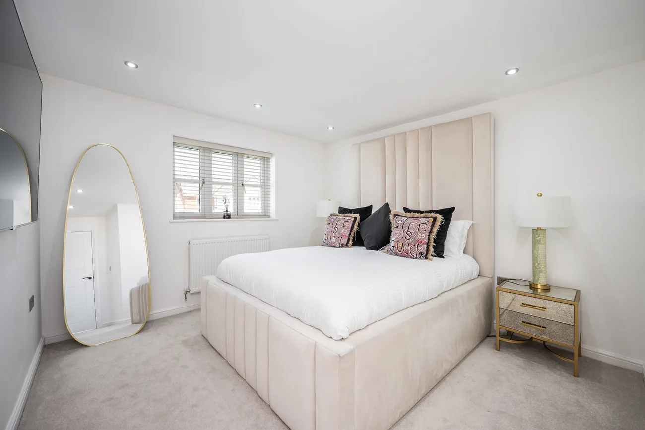 Principal bedroom with a large bed and soft neutral decor