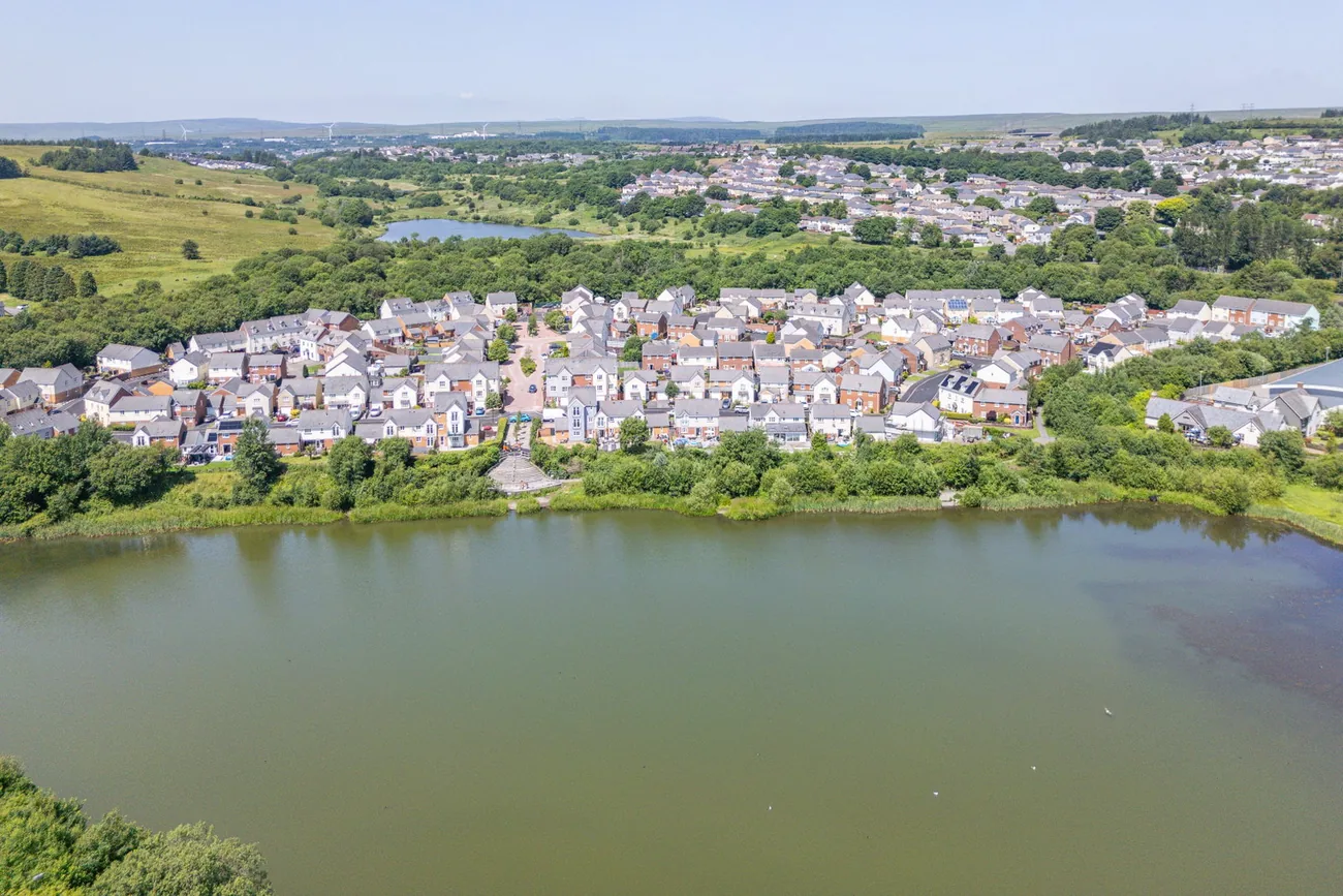 Aerial view of the lakeside development and the surrounding hills