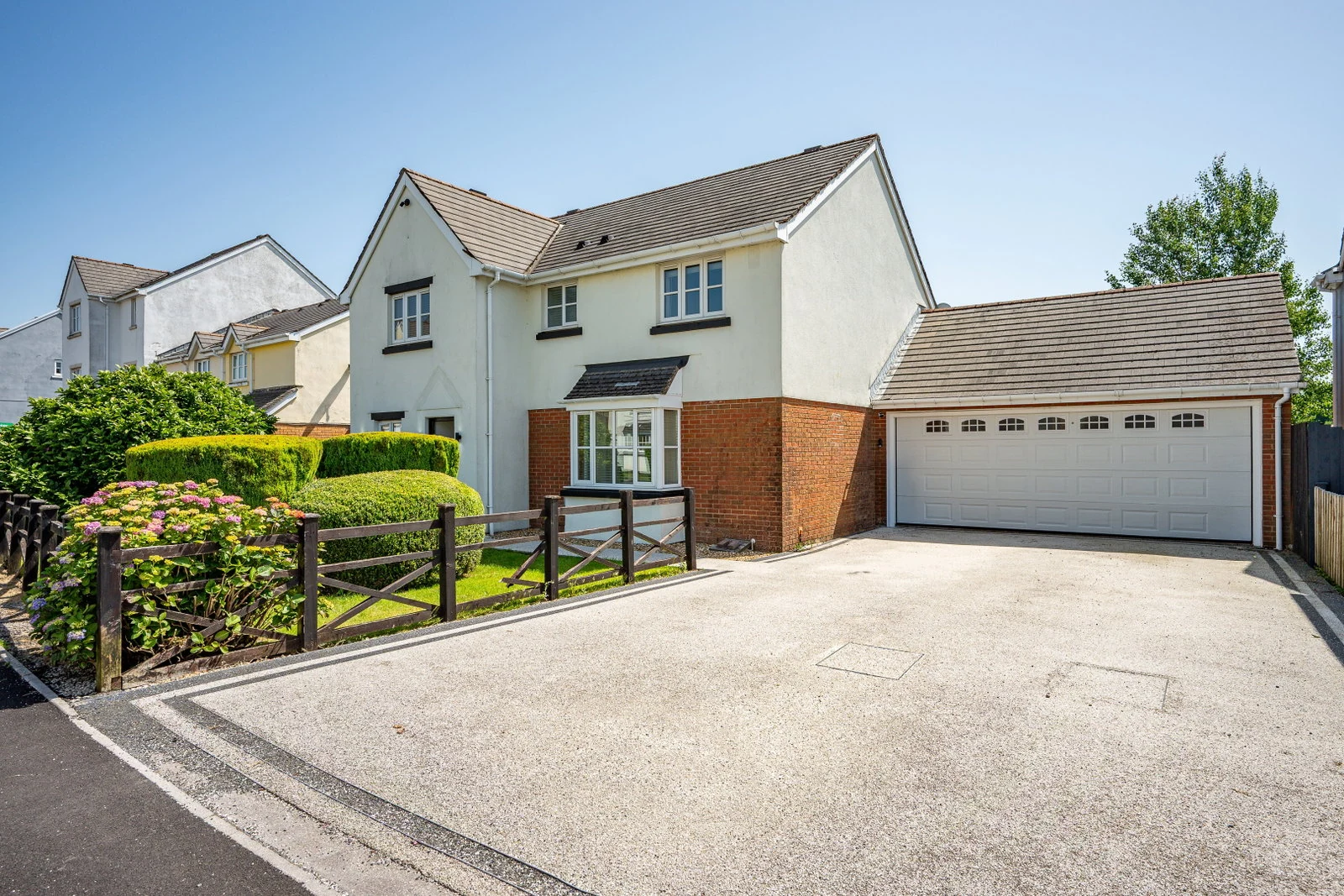The front of 113 Lakeside Way, a modern detached house with a deep private driveway and double garage