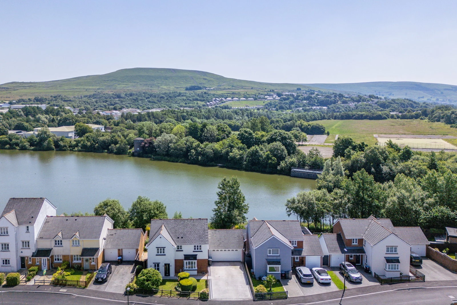 Aerial view of the lake with the Milfraen hills rising behind the development