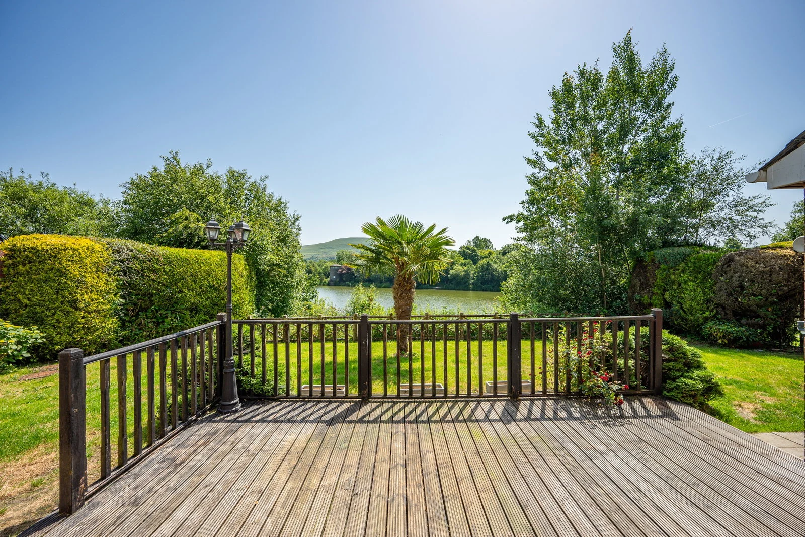 Raised deck overlooking the private garden and the lake beyond