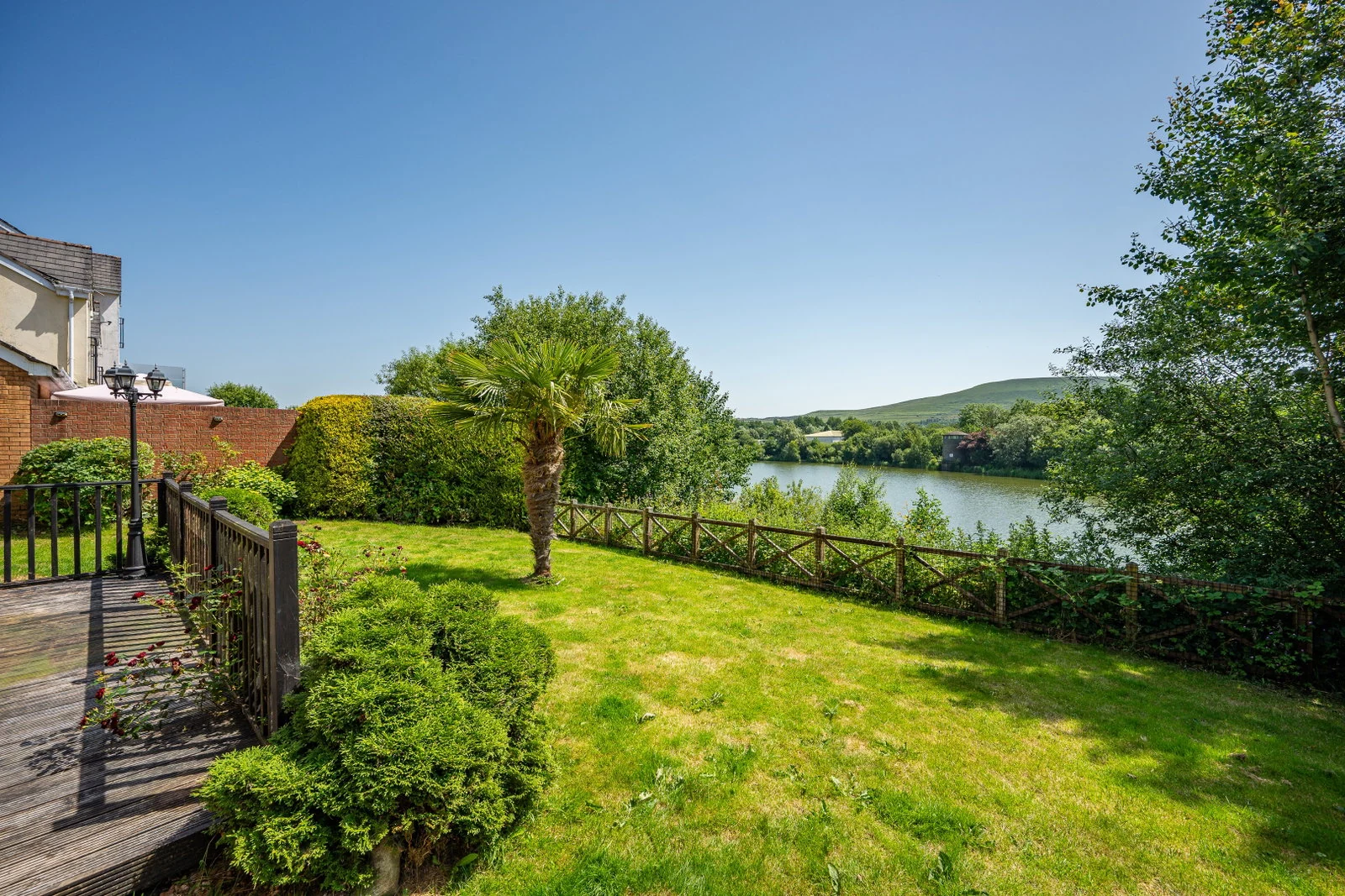 Private rear garden looking across the lawn to the lake